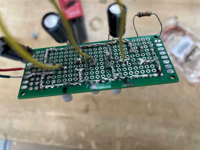 Wires and capacitors soldered to board